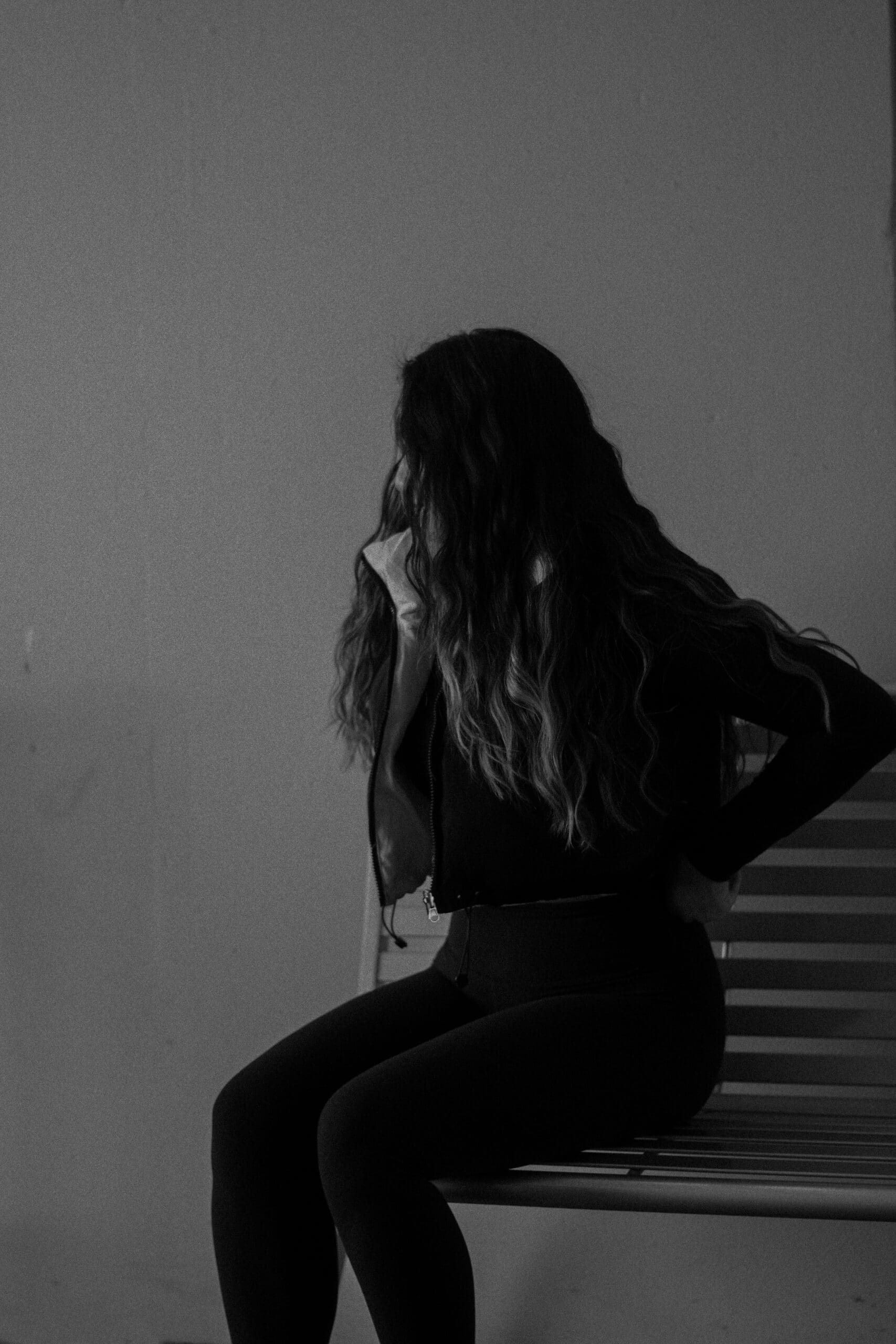 sitting on the bench in black and white