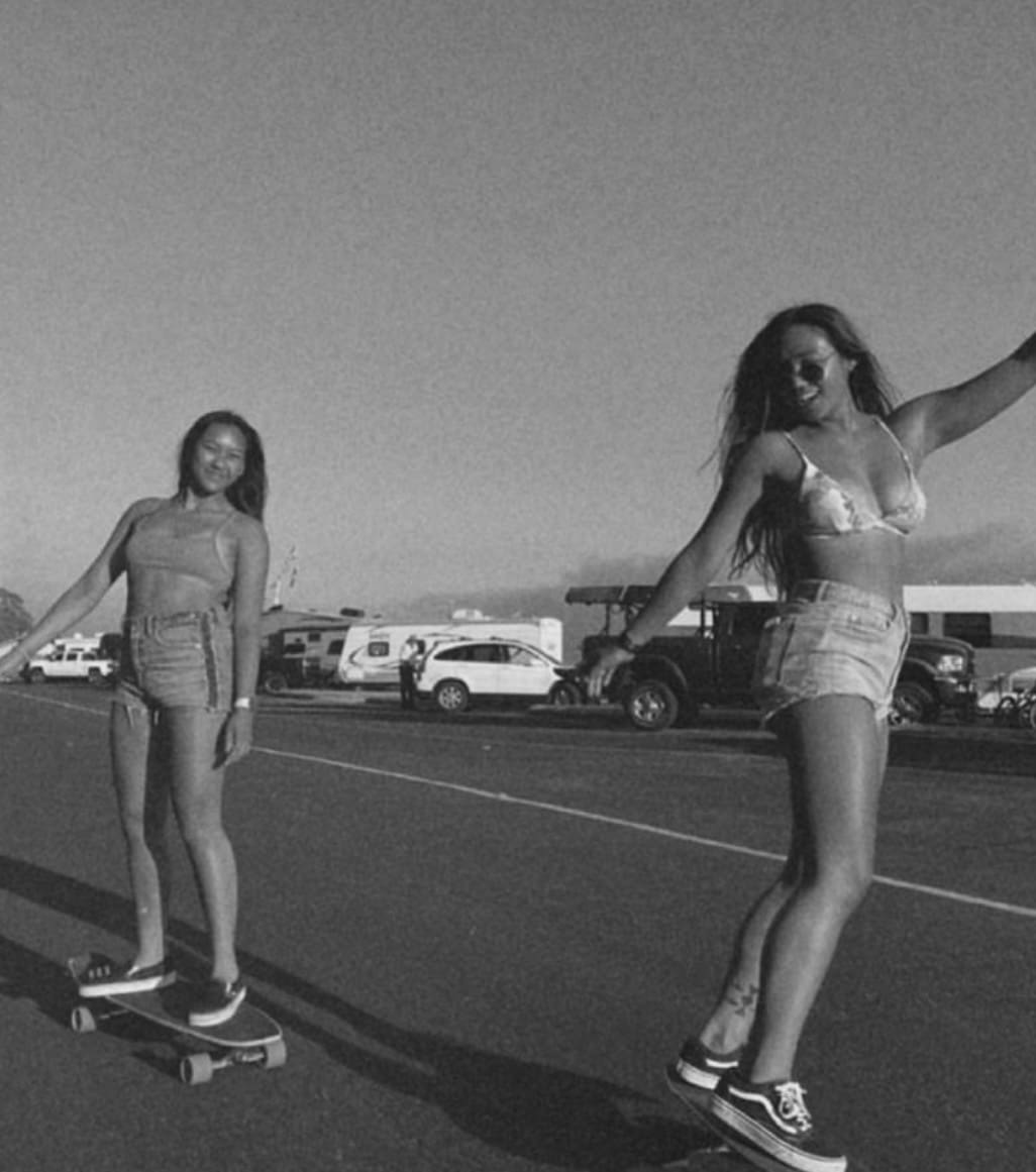 two girls skating at the beach