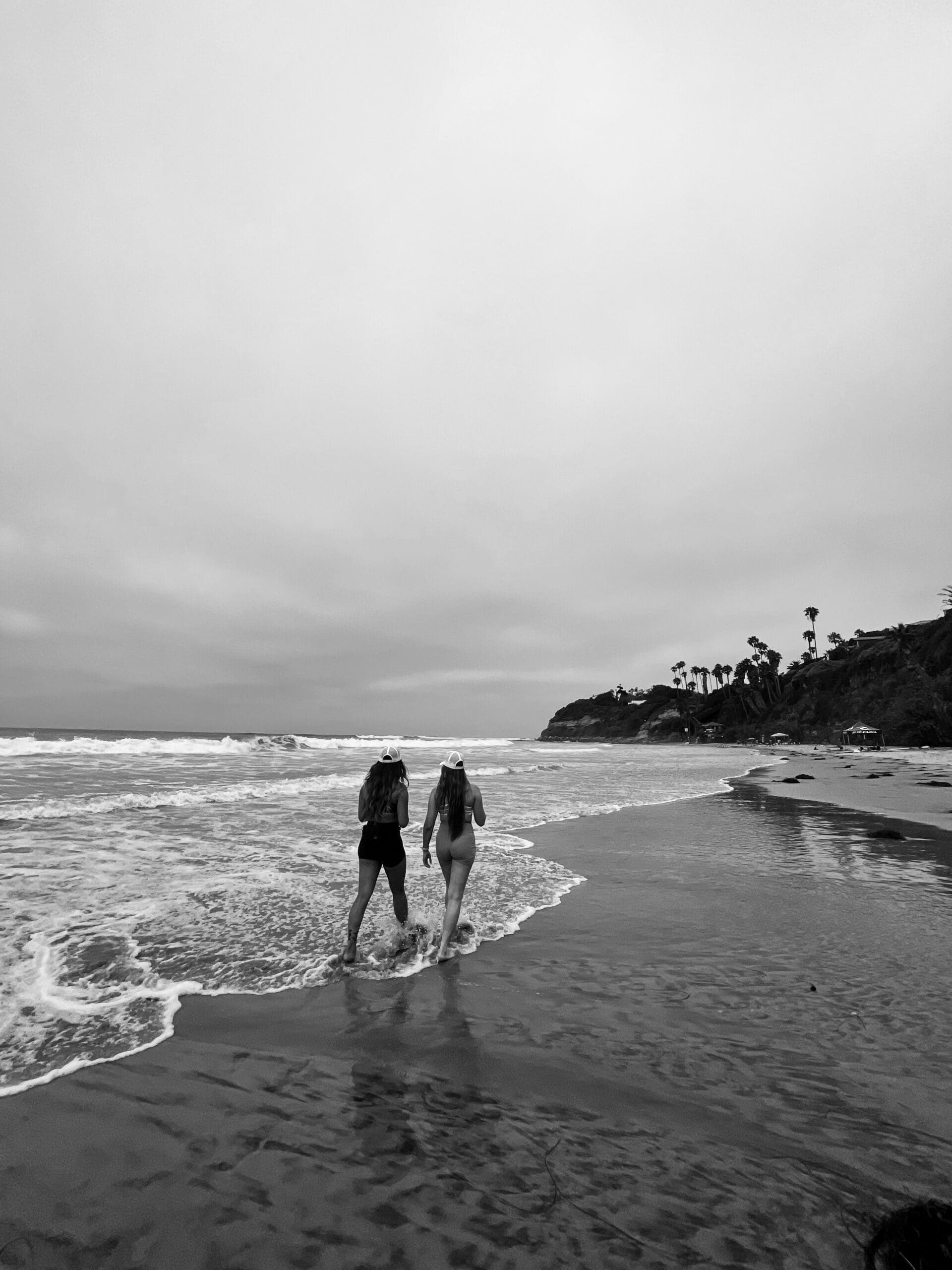 two friends walking on the beach